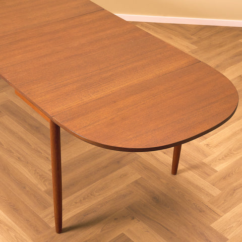 Danish dining table with 4 extensions in teak "Arne Vodder style"