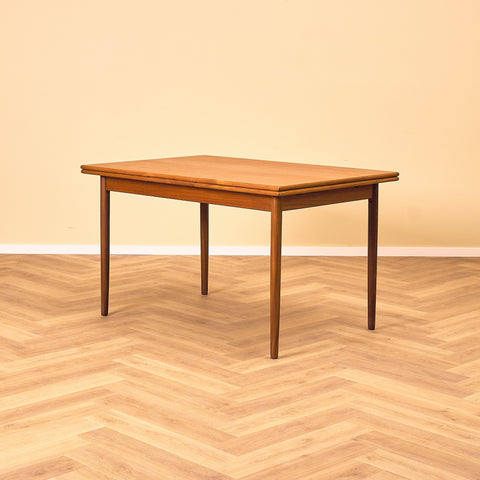 Danish dining table in teak and walnut