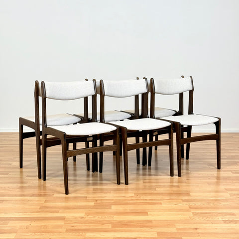 Danish dining chairs in solid stained oak by Erik Buch