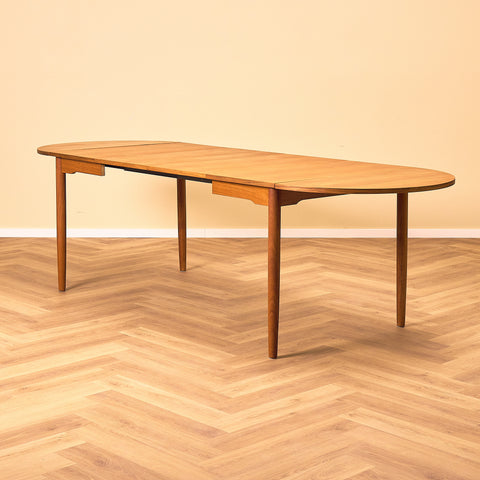 Danish dining table with 4 extensions in teak "Arne Vodder style"